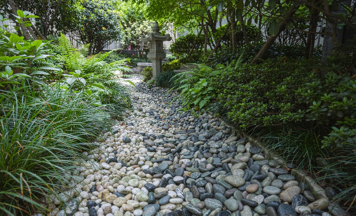 Light pebbles edging a dry stream in a Japanese garden
