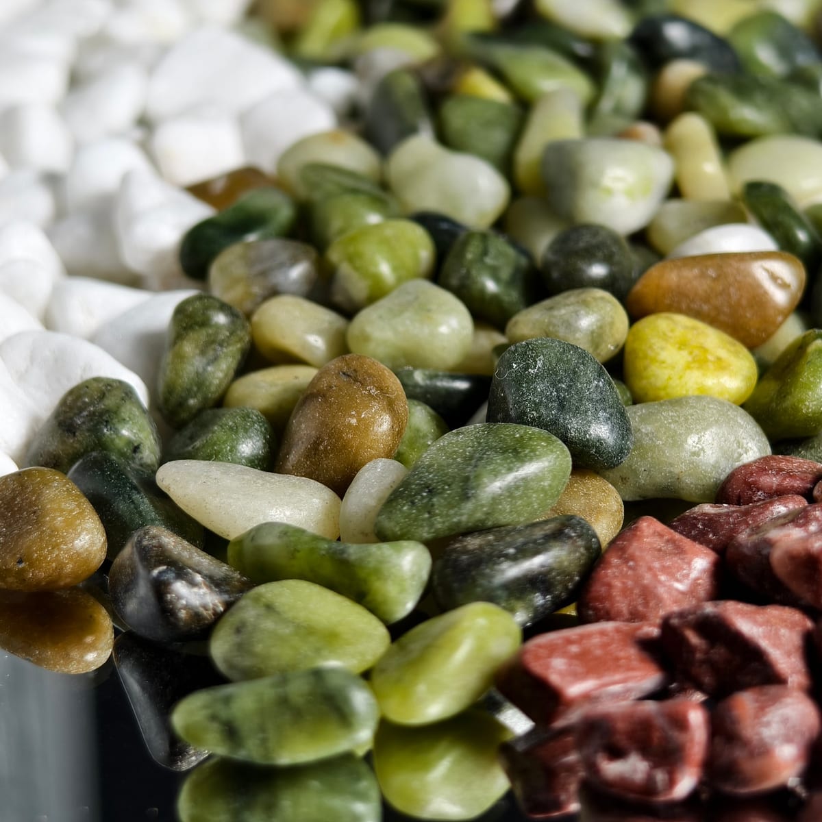 Close-up of garden pebbles in mixed red and green tones