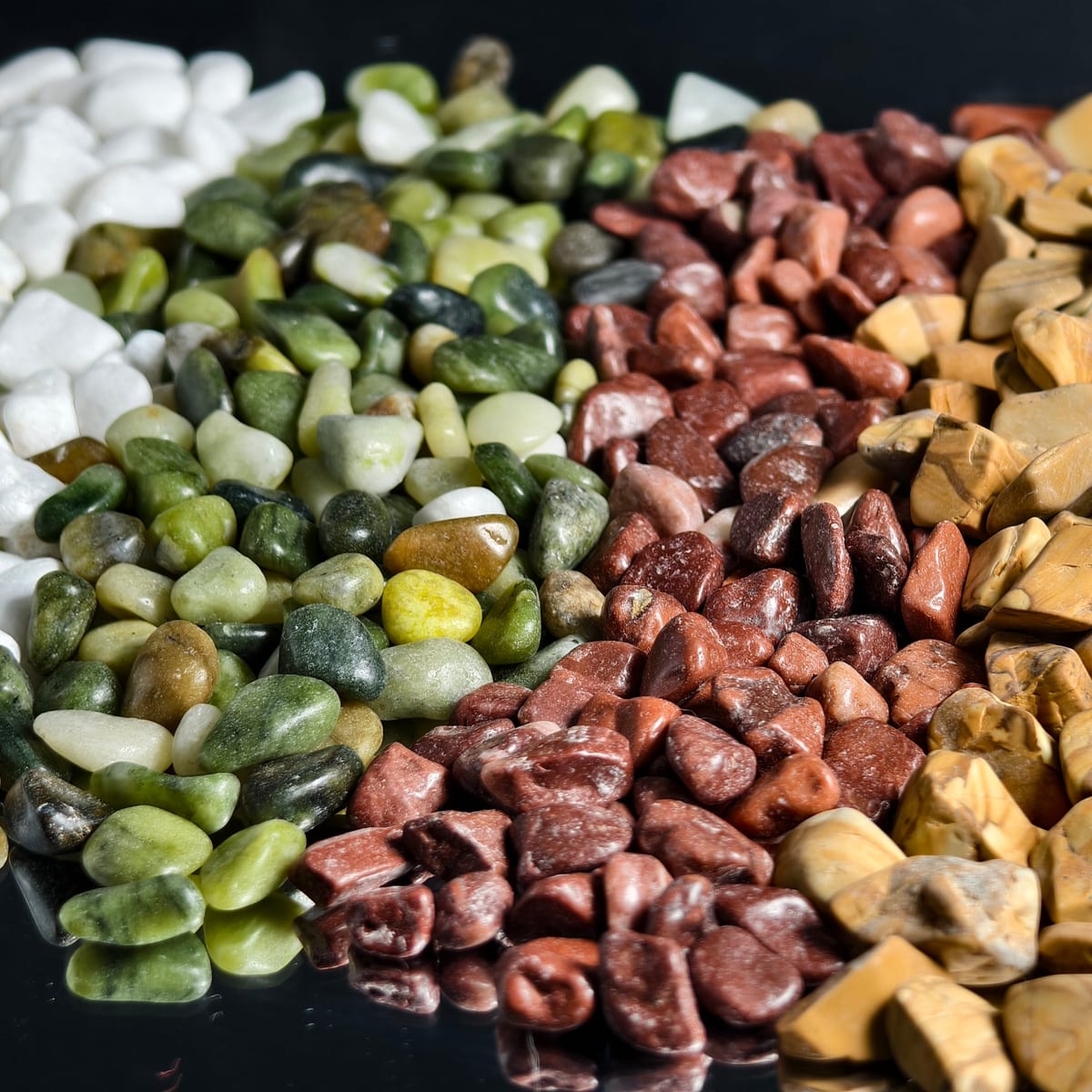 Close-up of mixed color decorative pebbles showing natural tonal variety