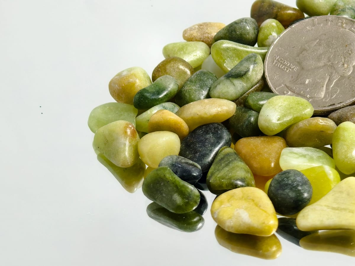 Natural pebble stockpile with coin size reference