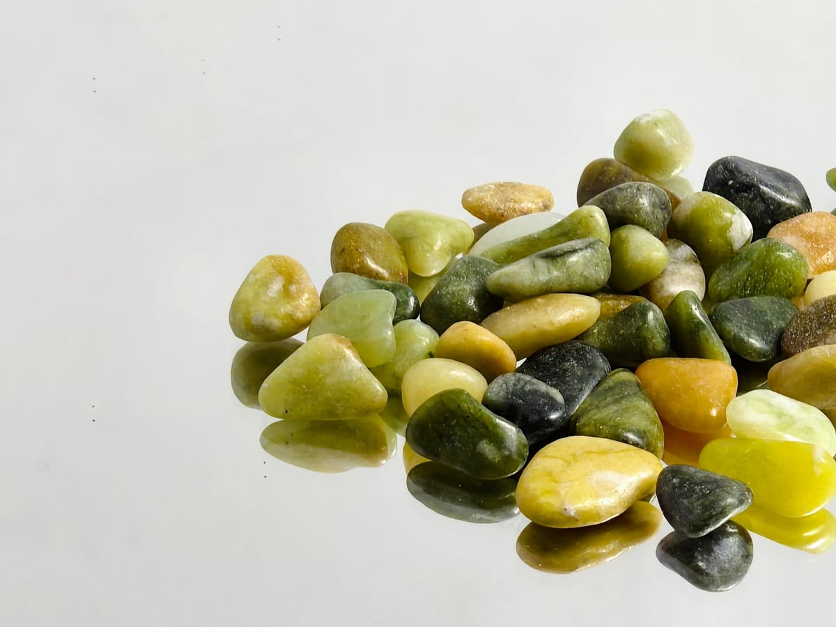 Polished pebble mix in green and golden tones