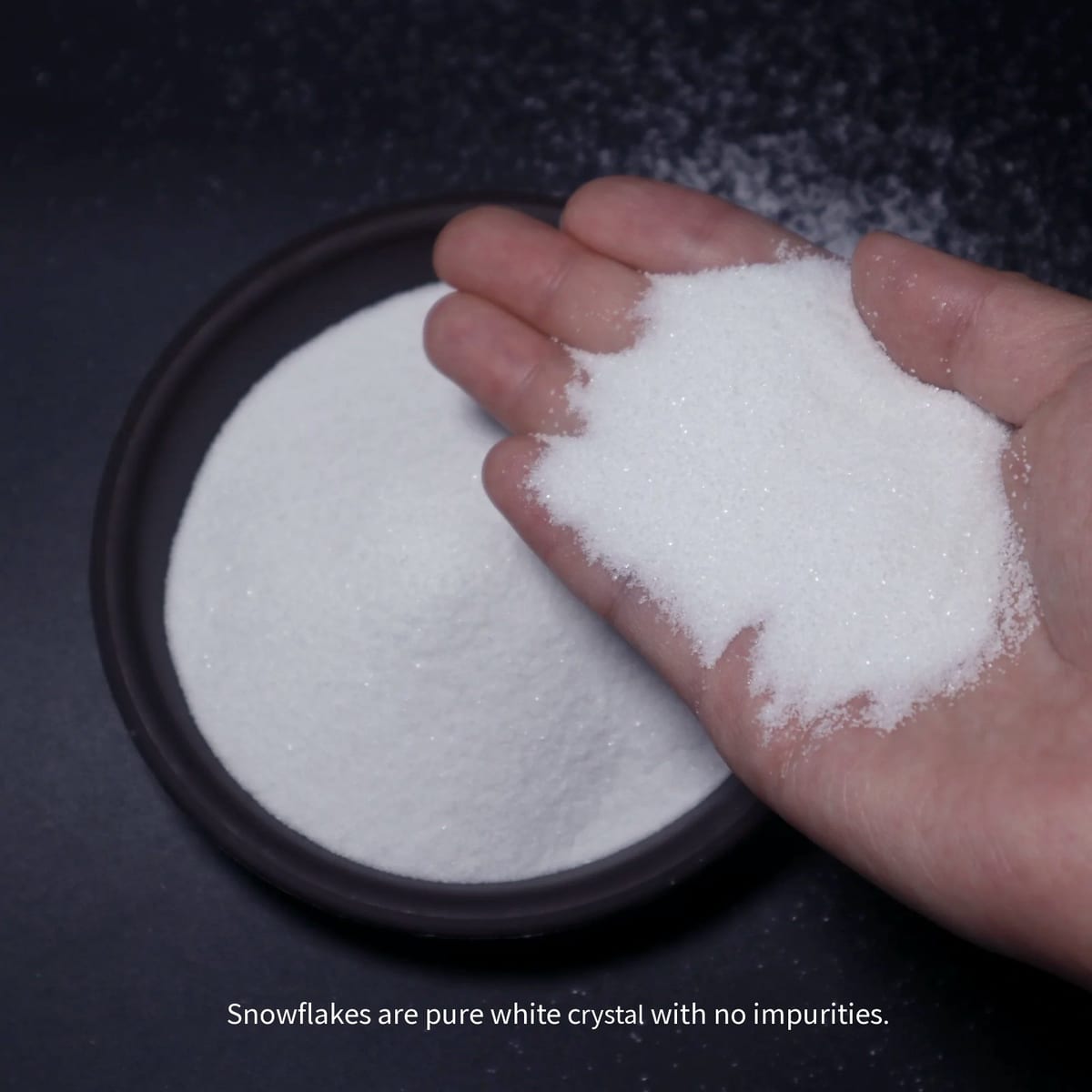 White sand held in hand to show fine grain size